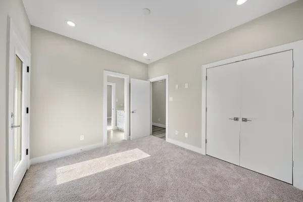 a kitchen with a refrigerator a sink and cabinets