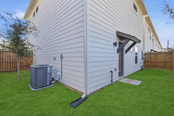 a view of a backyard with wooden fence