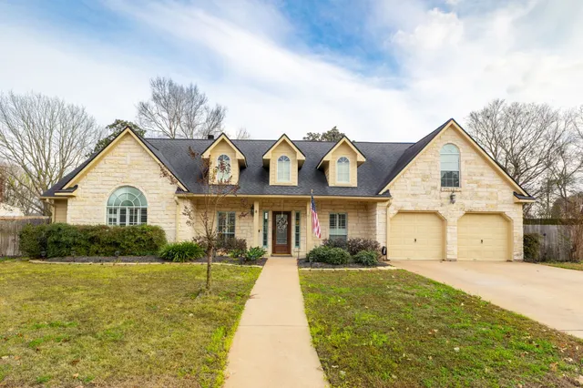 a view of house with yard and green space