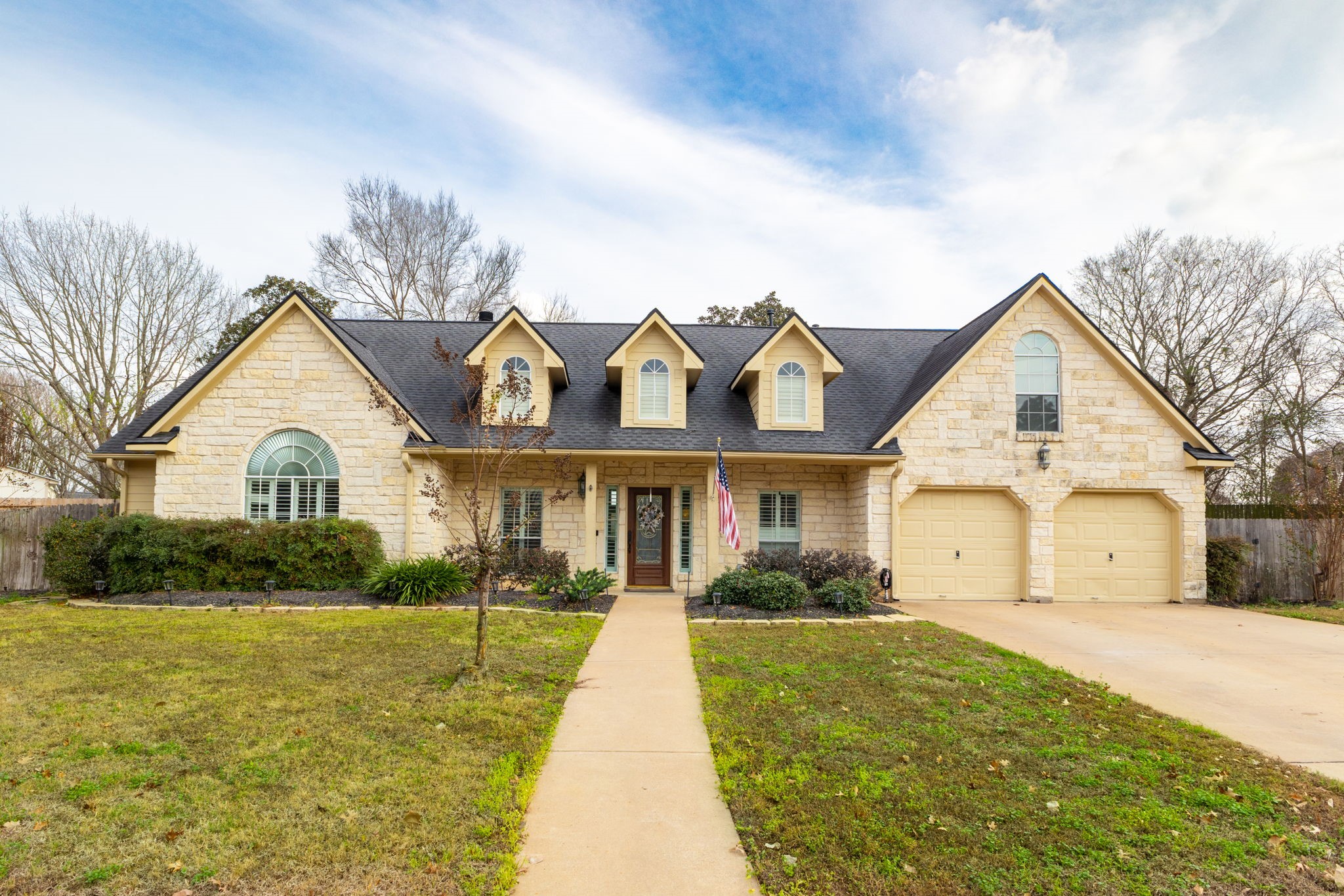 a view of house with yard and green space