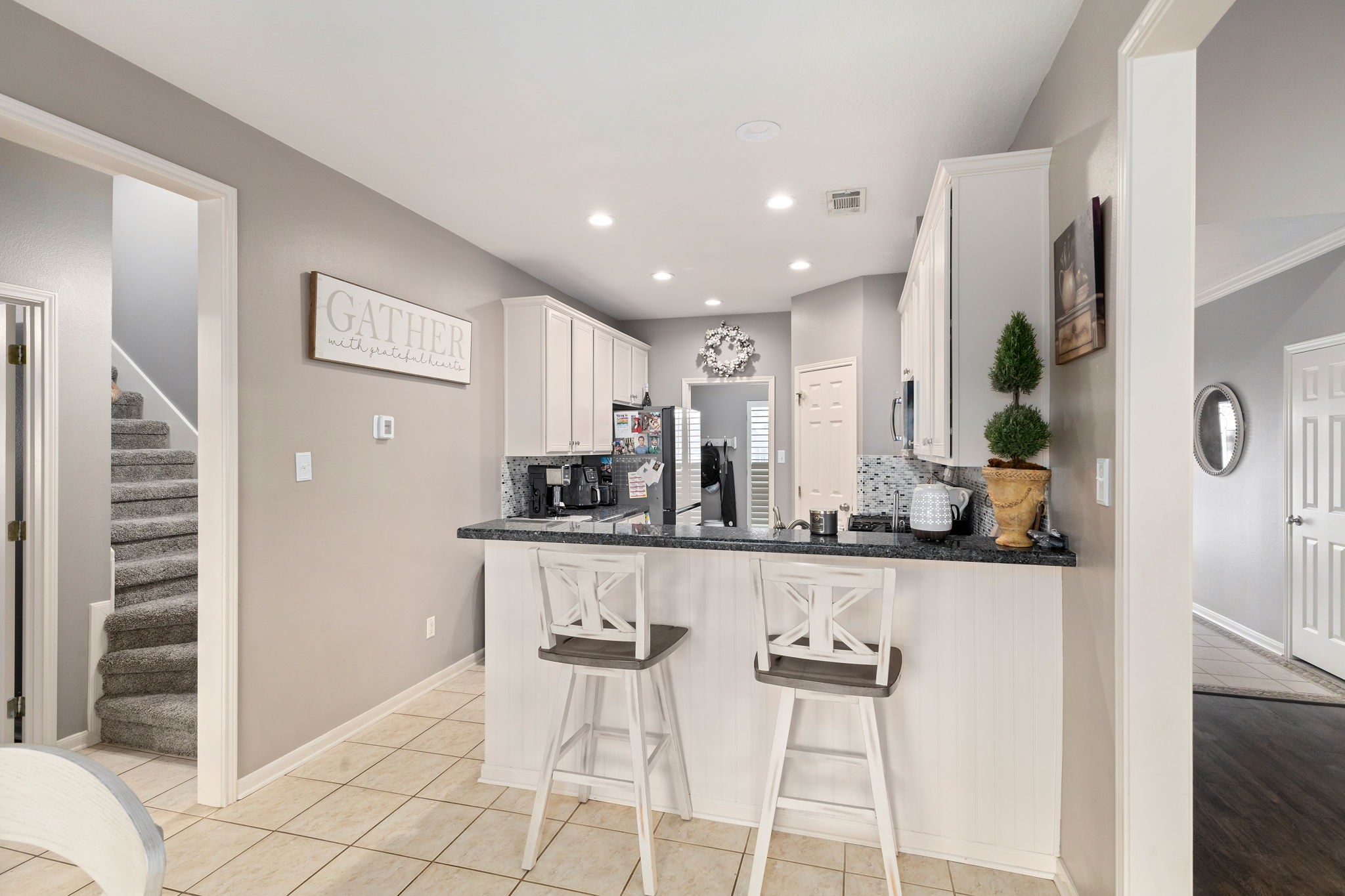 2709 Chase Street Brenham, TX 77833 - Photo 12 of 43 a kitchen with stainless steel appliances kitchen island granite countertop a refrigerator and cabinets