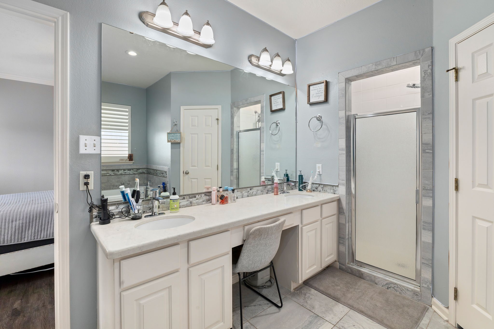 2709 Chase Street Brenham, TX 77833 - Photo 19 of 43 a bathroom with a sink double vanity and a mirror