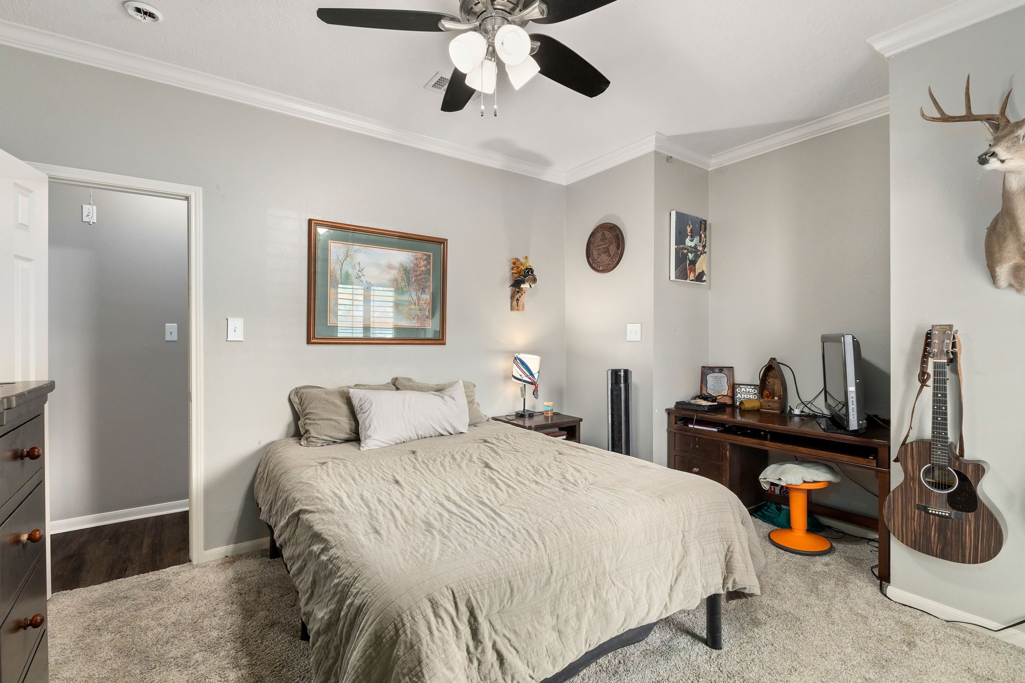 2709 Chase Street Brenham, TX 77833 - Photo 23 of 43 a bedroom with a bed and a chandelier