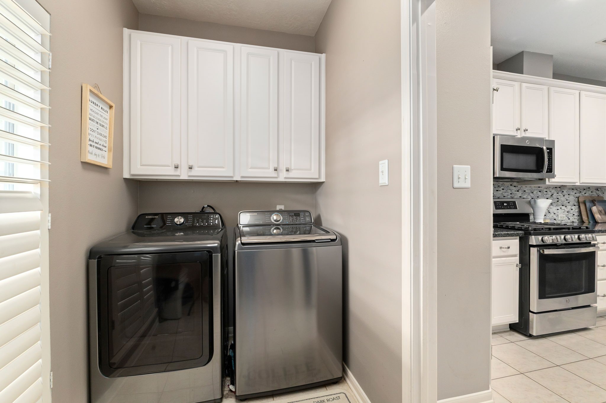 2709 Chase Street Brenham, TX 77833 - Photo 30 of 43 a kitchen with stainless steel appliances granite countertop a stove a refrigerator and a microwave