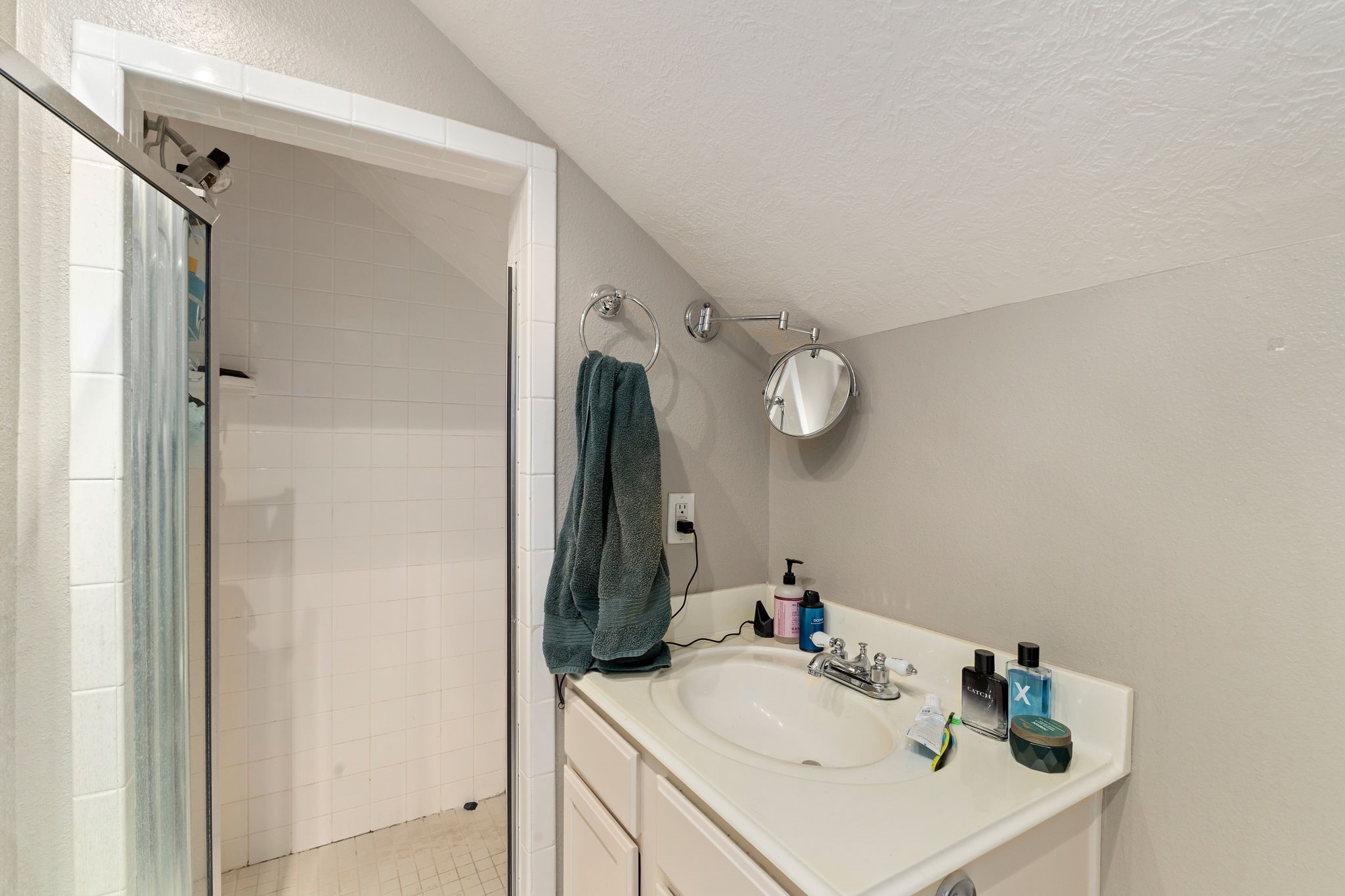 2709 Chase Street Brenham, TX 77833 - Photo 32 of 43 a bathroom with a sink and a mirror white cabinets
