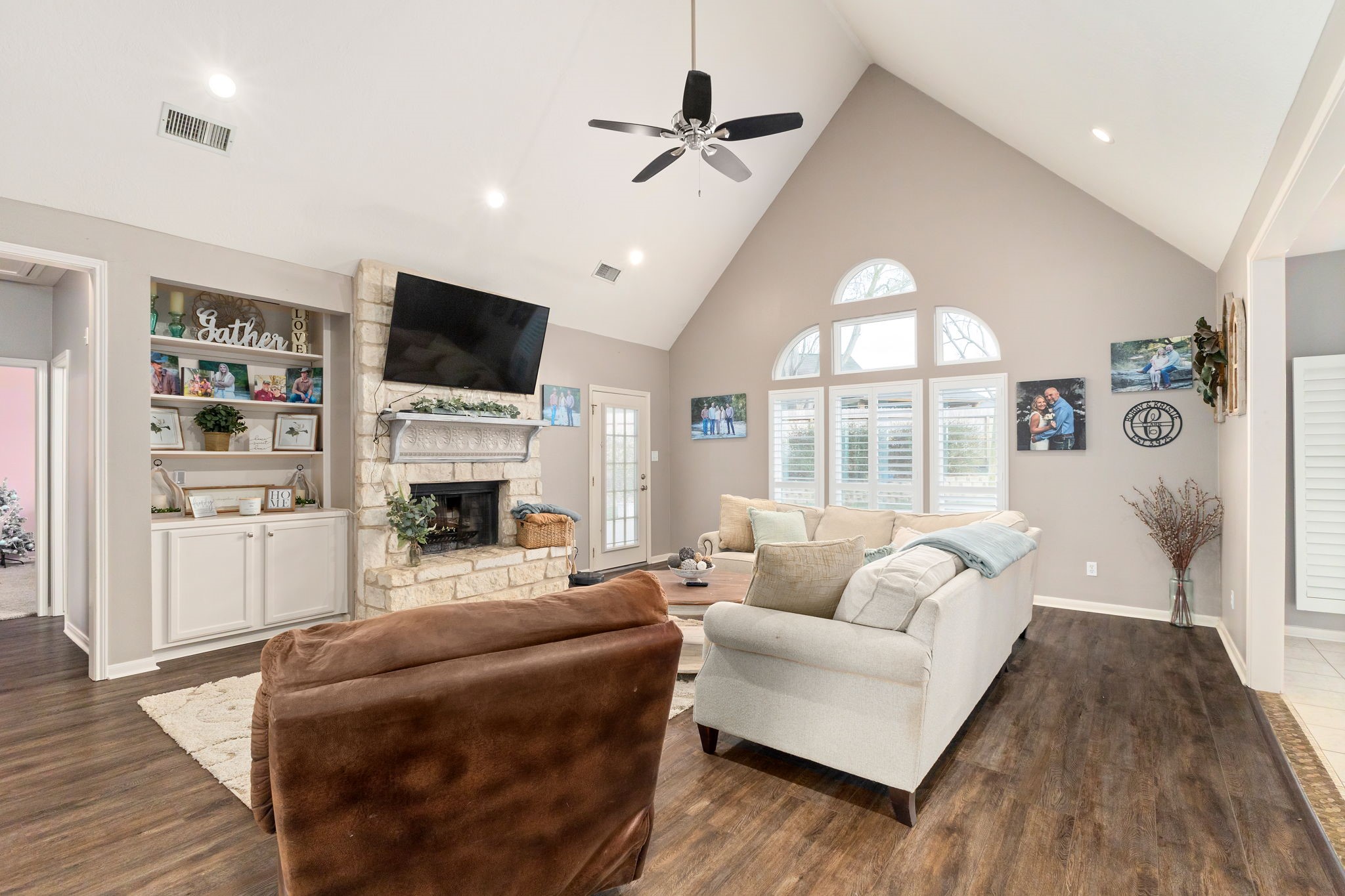 2709 Chase Street Brenham, TX 77833 - Photo 4 of 43 a living room with furniture a fireplace and a flat screen tv