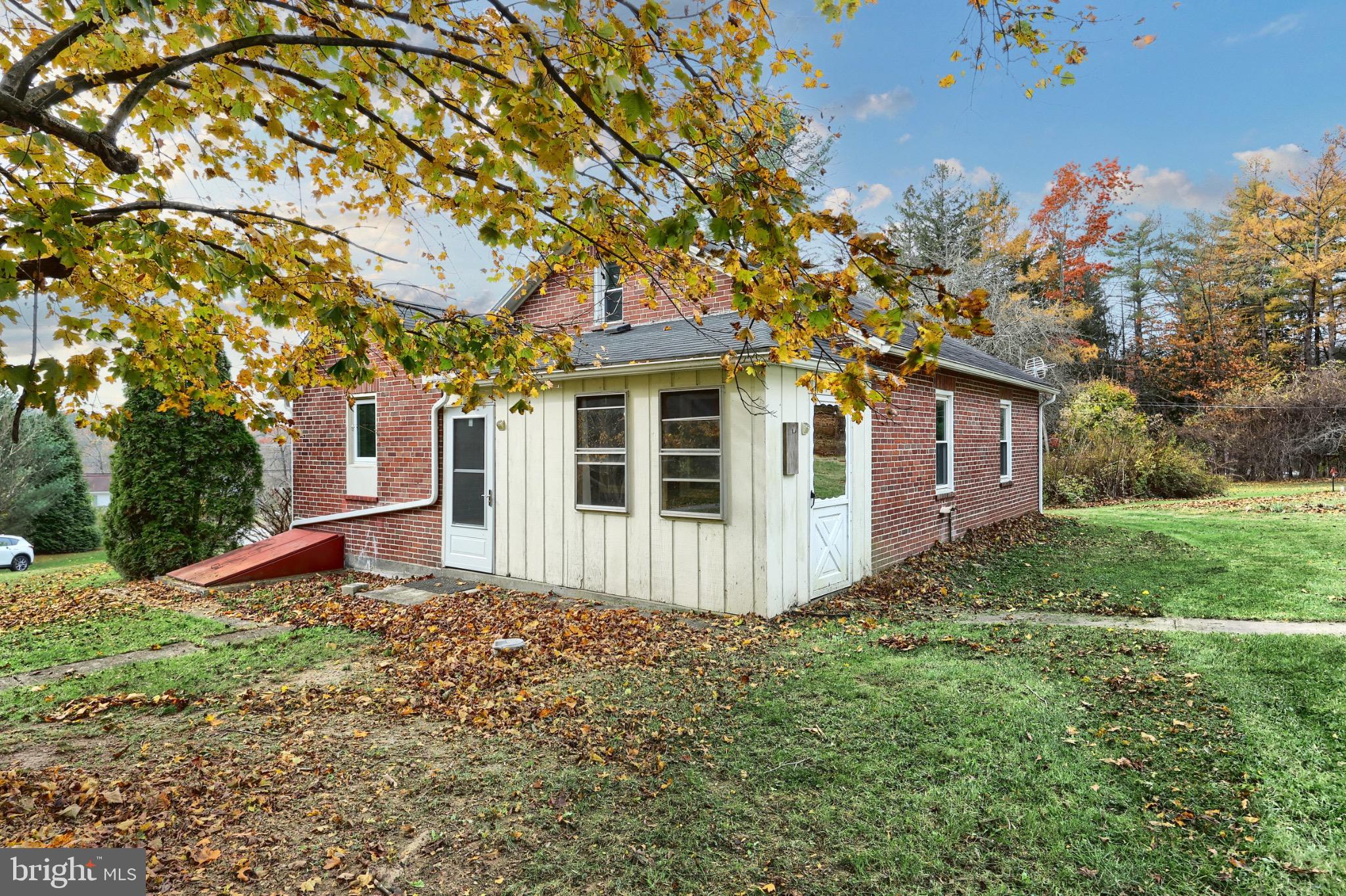 4599 Carlisle Road Gardners, PA 17324 - Photo 31 of 48 Charming brick home amidst autumn leaves.