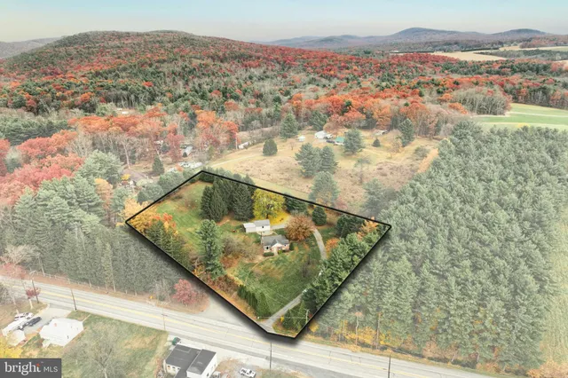 a view of a house with yard and green space