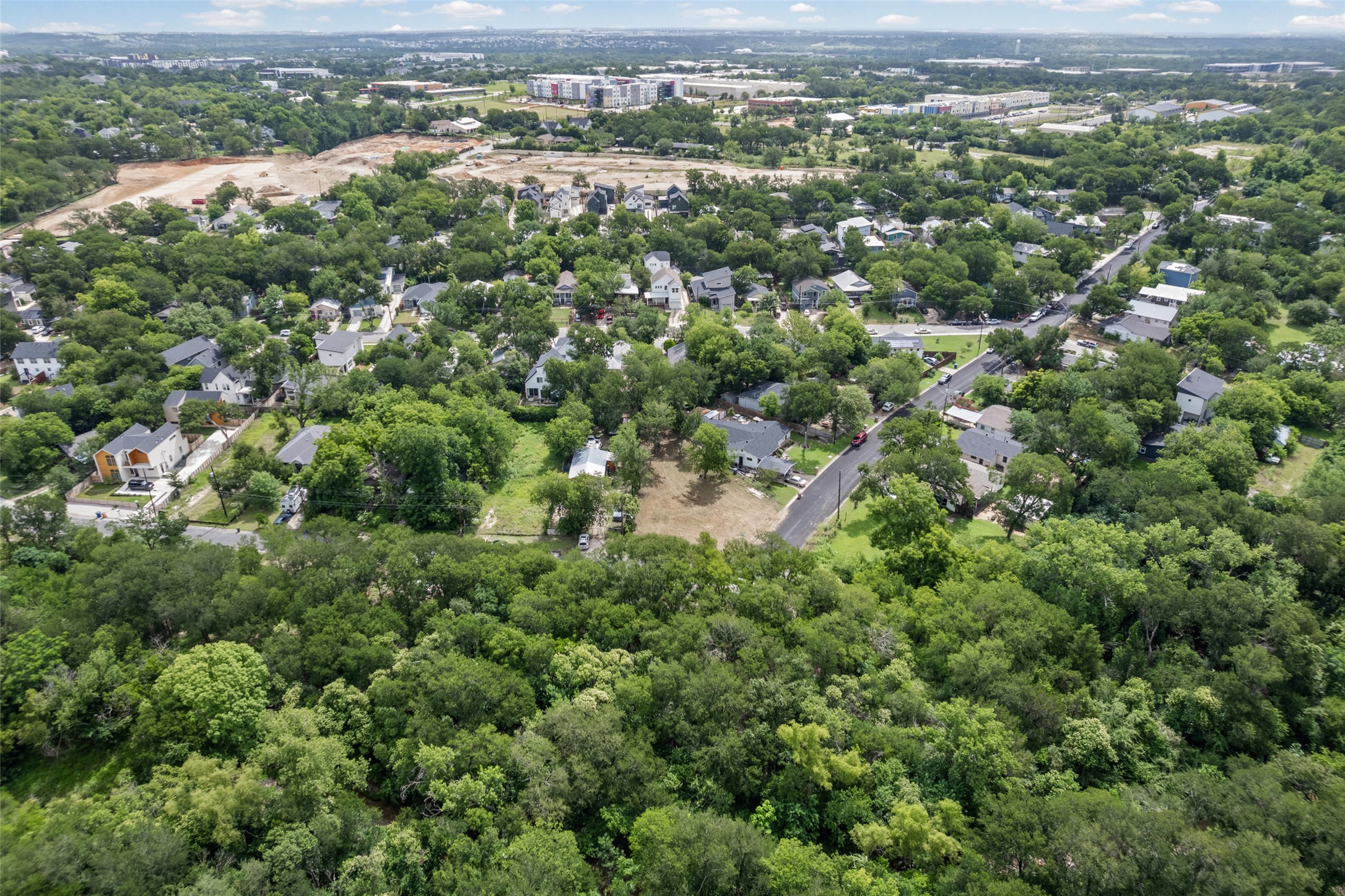 1201 Fort Branch Boulevard Austin, TX 78721 - Photo 10 of 19 An aerial panorama showcases a verdant residential area amidst lush tree canopy, offering tranquil living.