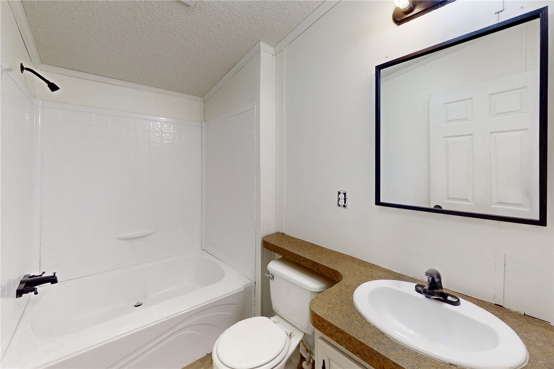 11459 Winstead Lane Calvert, TX 77837 - Photo 12 of 37 a bathroom with a sink toilet and shower