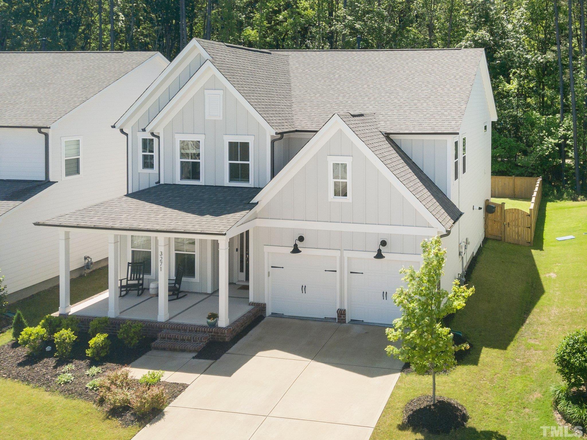 3271 Ripley River Road New Hill, NC 27562 - Photo 1 of 48 a view of a white house with a yard and a chandelier