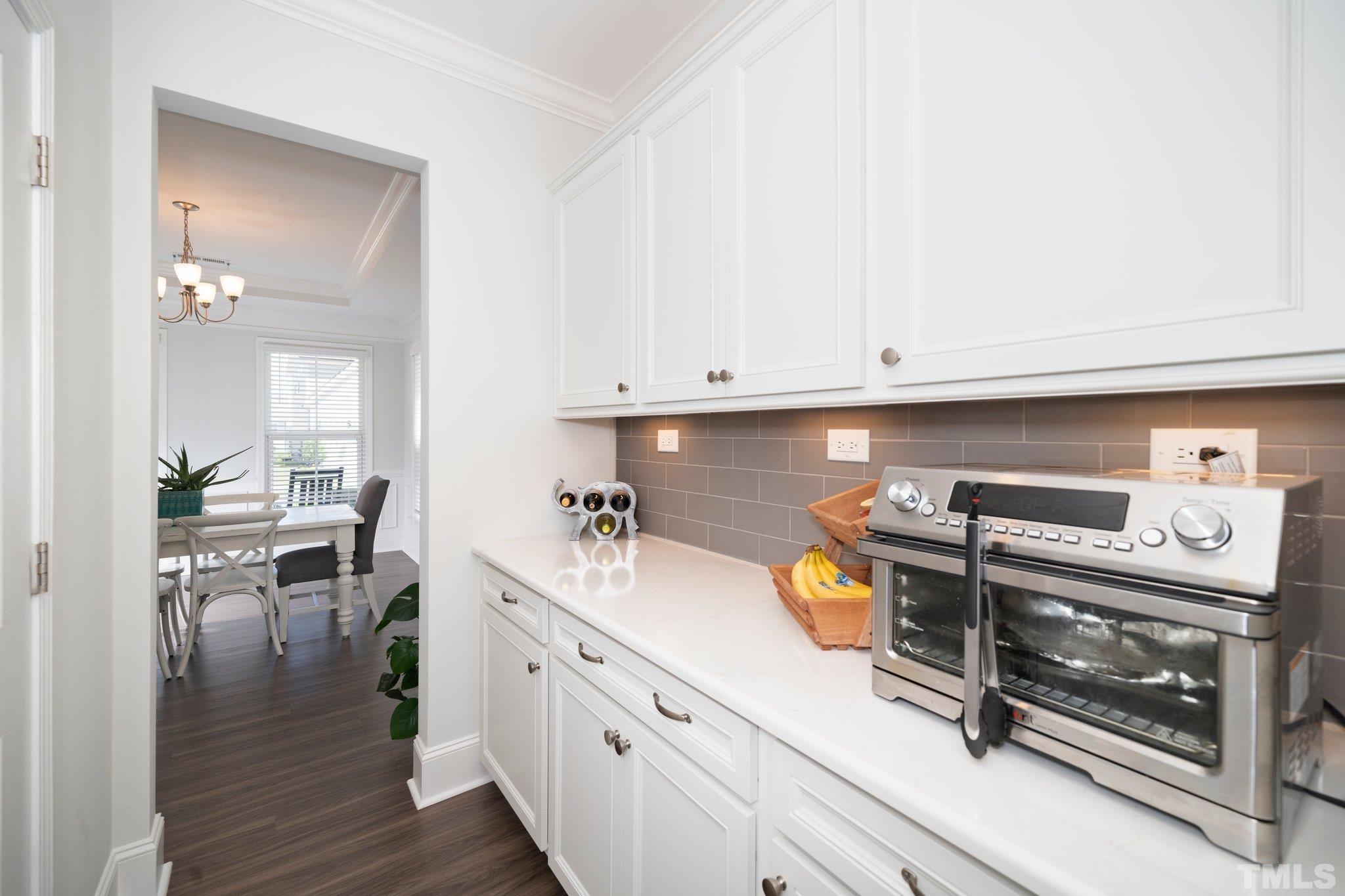 3271 Ripley River Road New Hill, NC 27562 - Photo 12 of 48 a kitchen with a stove and white cabinets