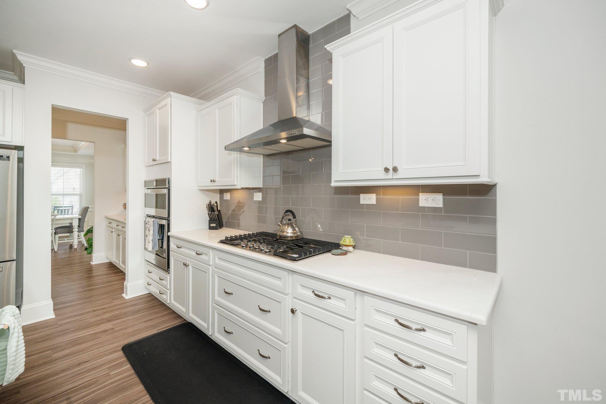 3271 Ripley River Road New Hill, NC 27562 - Photo 14 of 48 a kitchen with stainless steel appliances white cabinets and a stove