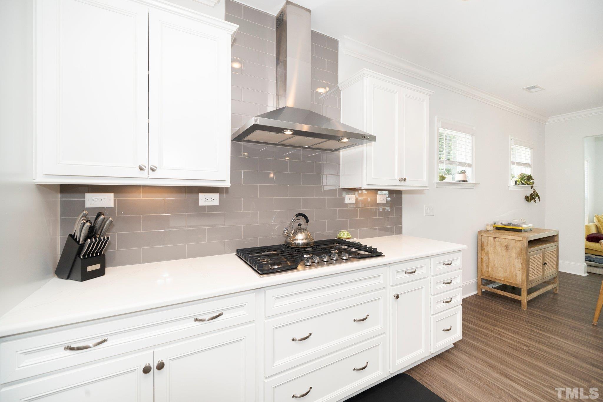 3271 Ripley River Road New Hill, NC 27562 - Photo 15 of 48 a kitchen with a stove a sink and cabinets
