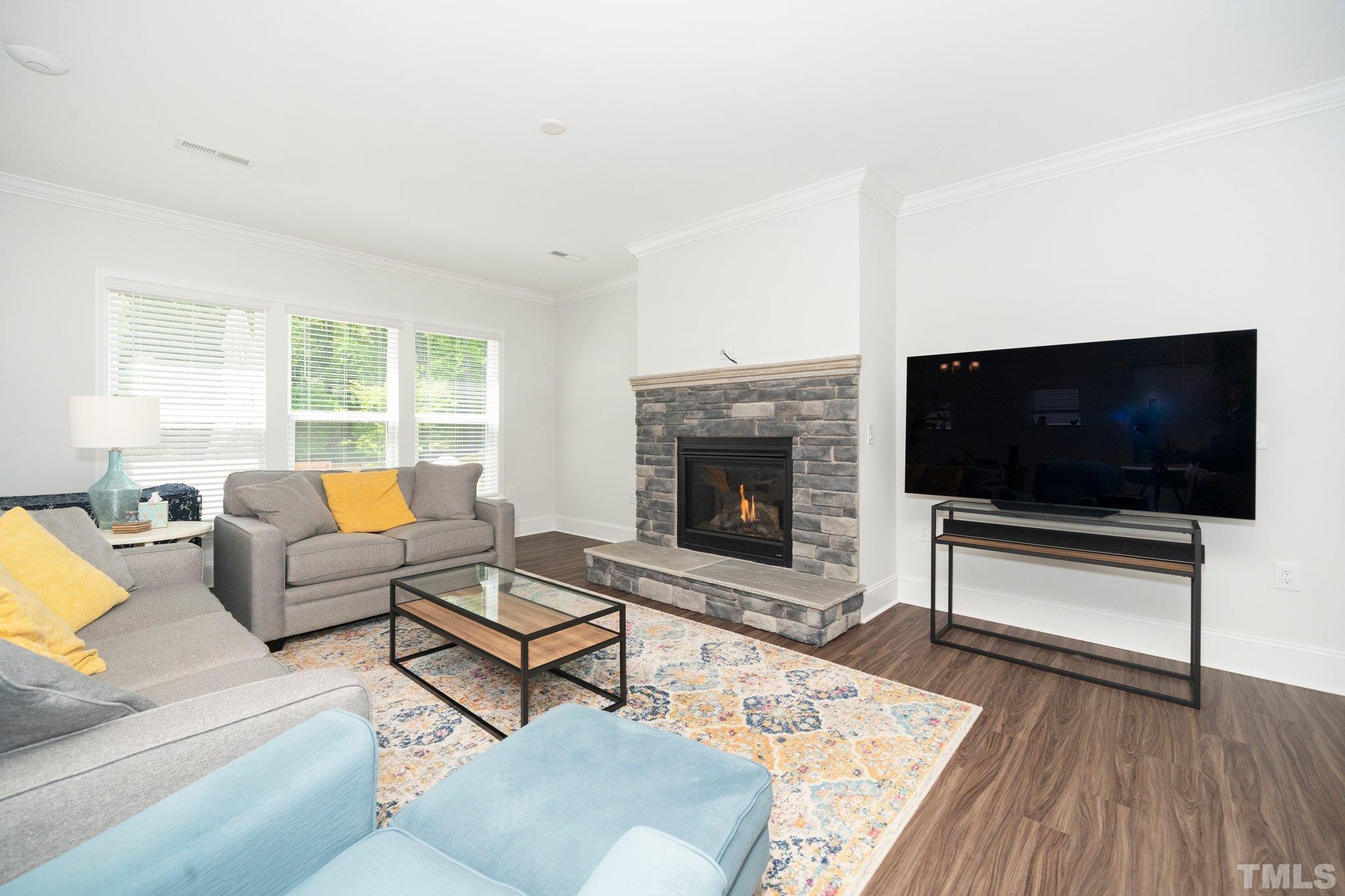 3271 Ripley River Road New Hill, NC 27562 - Photo 16 of 48 a living room with furniture and a flat screen tv