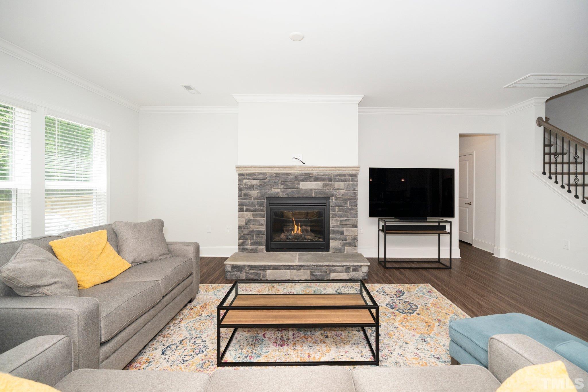 3271 Ripley River Road New Hill, NC 27562 - Photo 18 of 48 a living room with furniture a rug and a flat screen tv