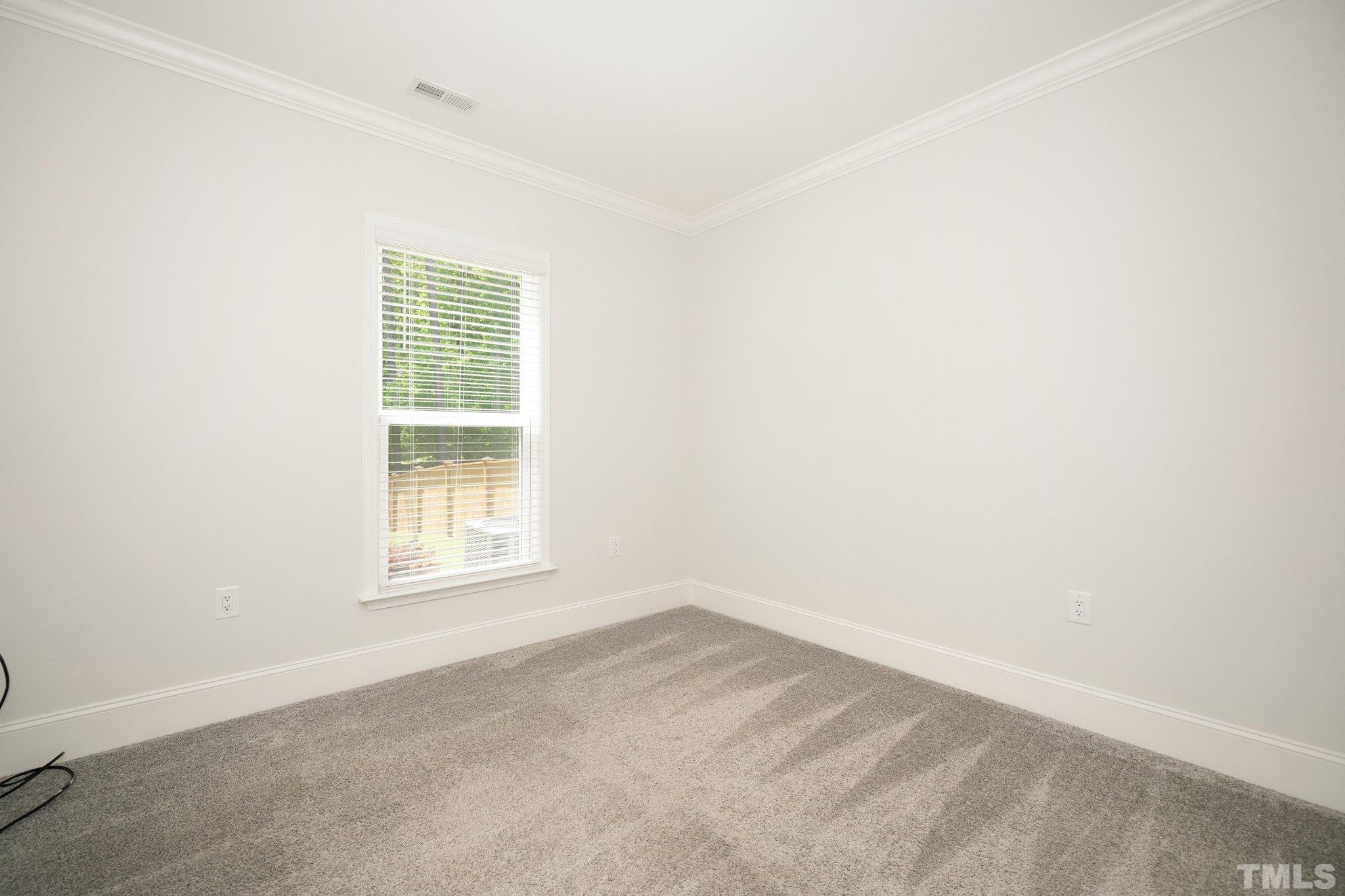 3271 Ripley River Road New Hill, NC 27562 - Photo 21 of 48 an empty room with a window