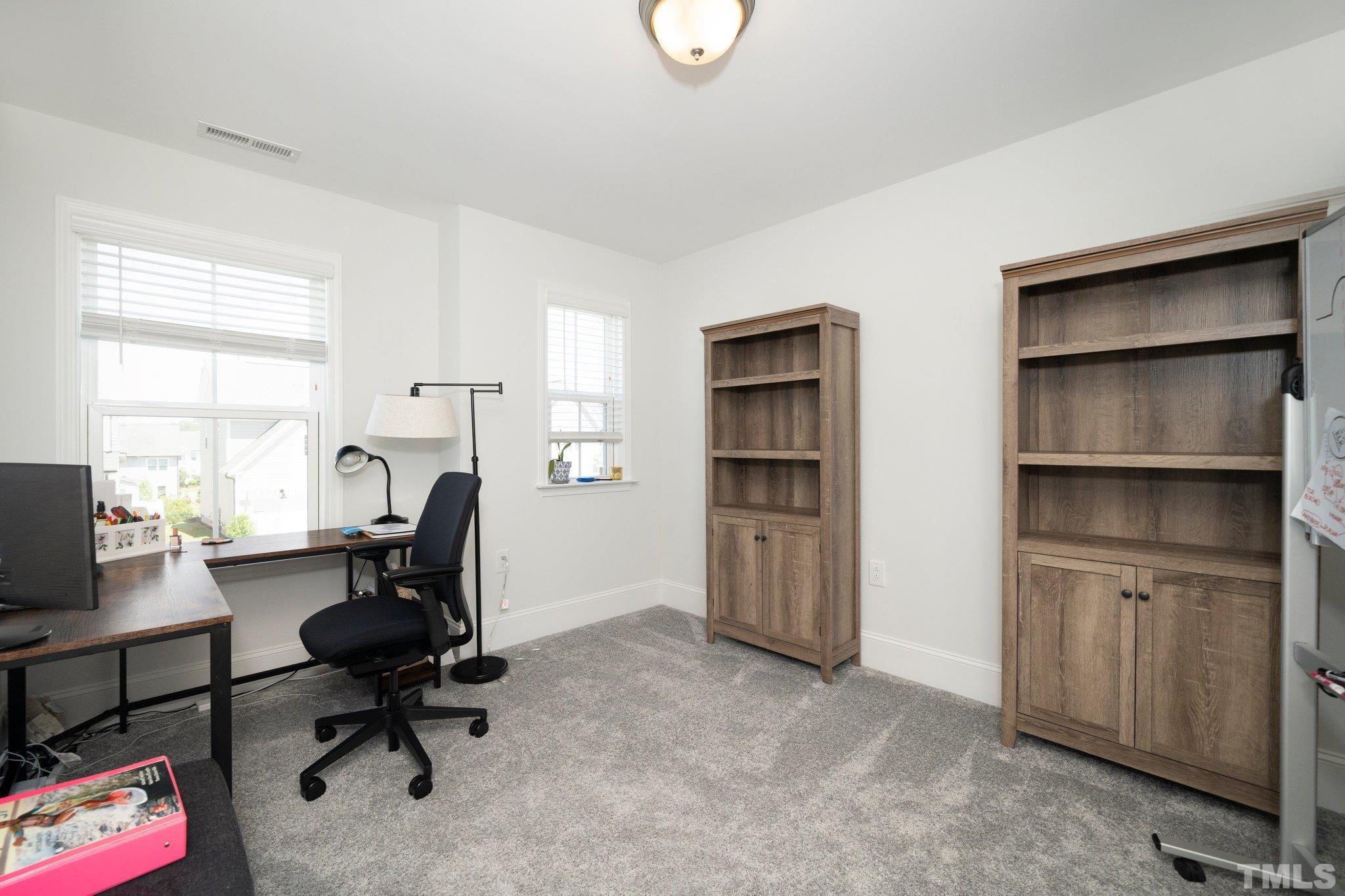 3271 Ripley River Road New Hill, NC 27562 - Photo 28 of 48 a view of a workspace with furniture and a window
