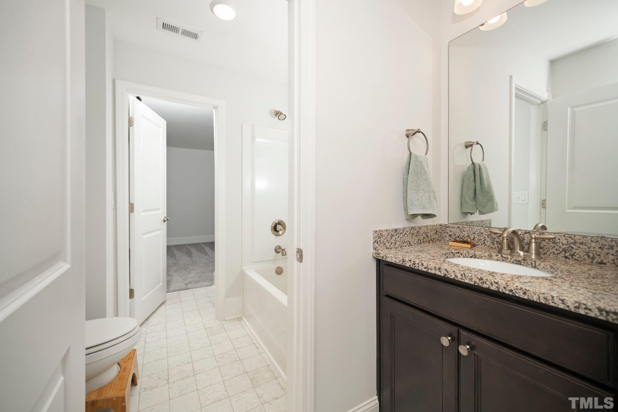 3271 Ripley River Road New Hill, NC 27562 - Photo 29 of 48 a bathroom with a granite countertop sink and a mirror
