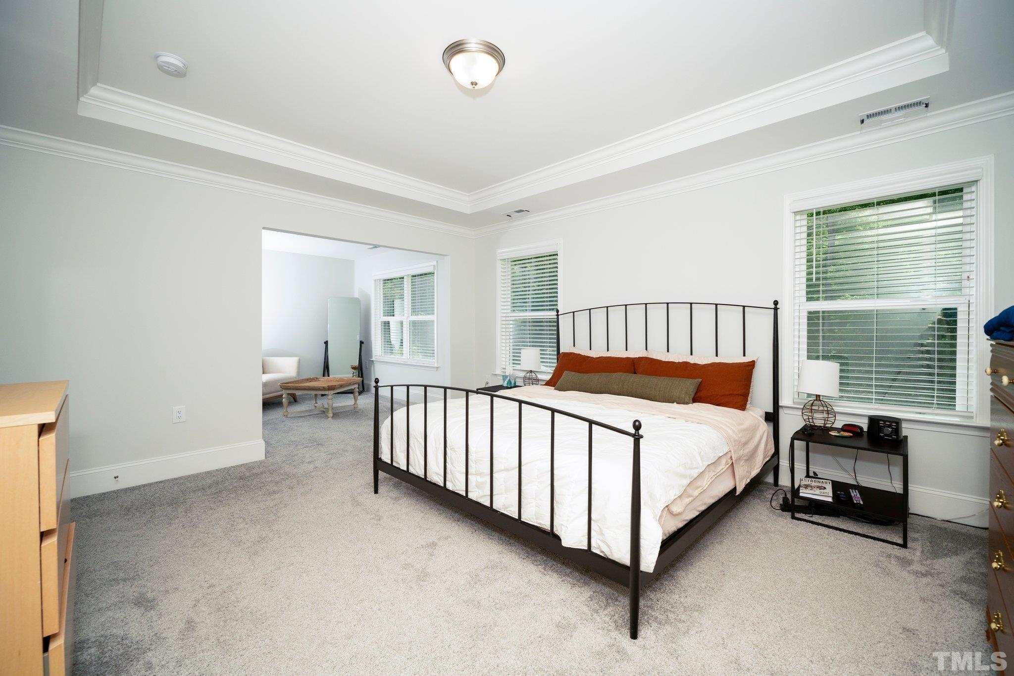 3271 Ripley River Road New Hill, NC 27562 - Photo 32 of 48 a bed room with a bed and a chair