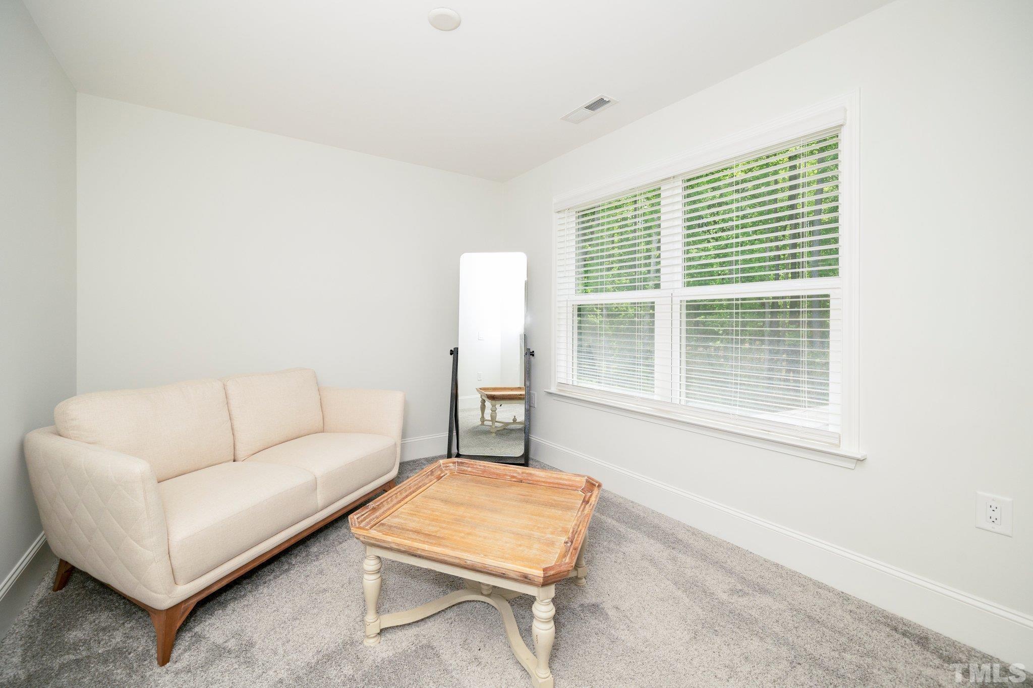 3271 Ripley River Road New Hill, NC 27562 - Photo 33 of 48 a living room with furniture and a window
