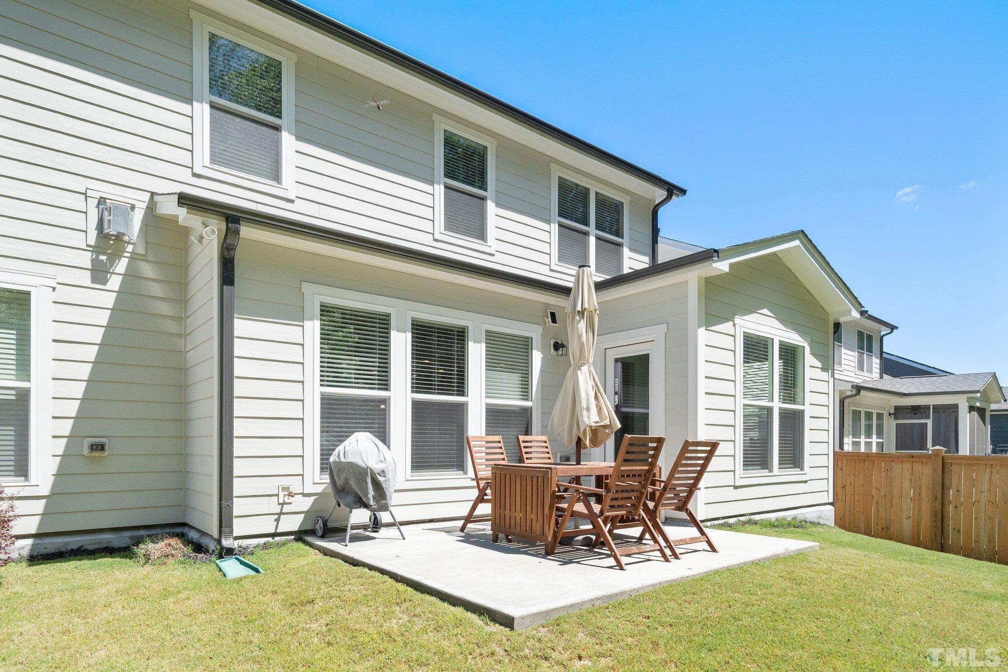 3271 Ripley River Road New Hill, NC 27562 - Photo 36 of 48 a view of a house with a patio and a yard
