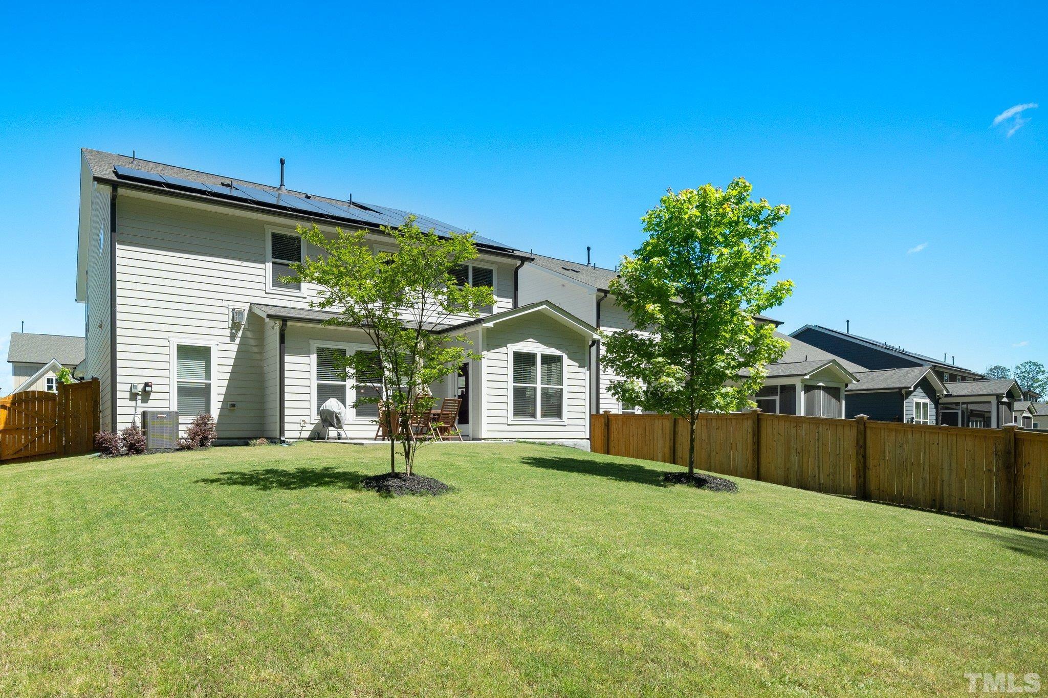 3271 Ripley River Road New Hill, NC 27562 - Photo 40 of 48 a backyard of a house with a garden and plants