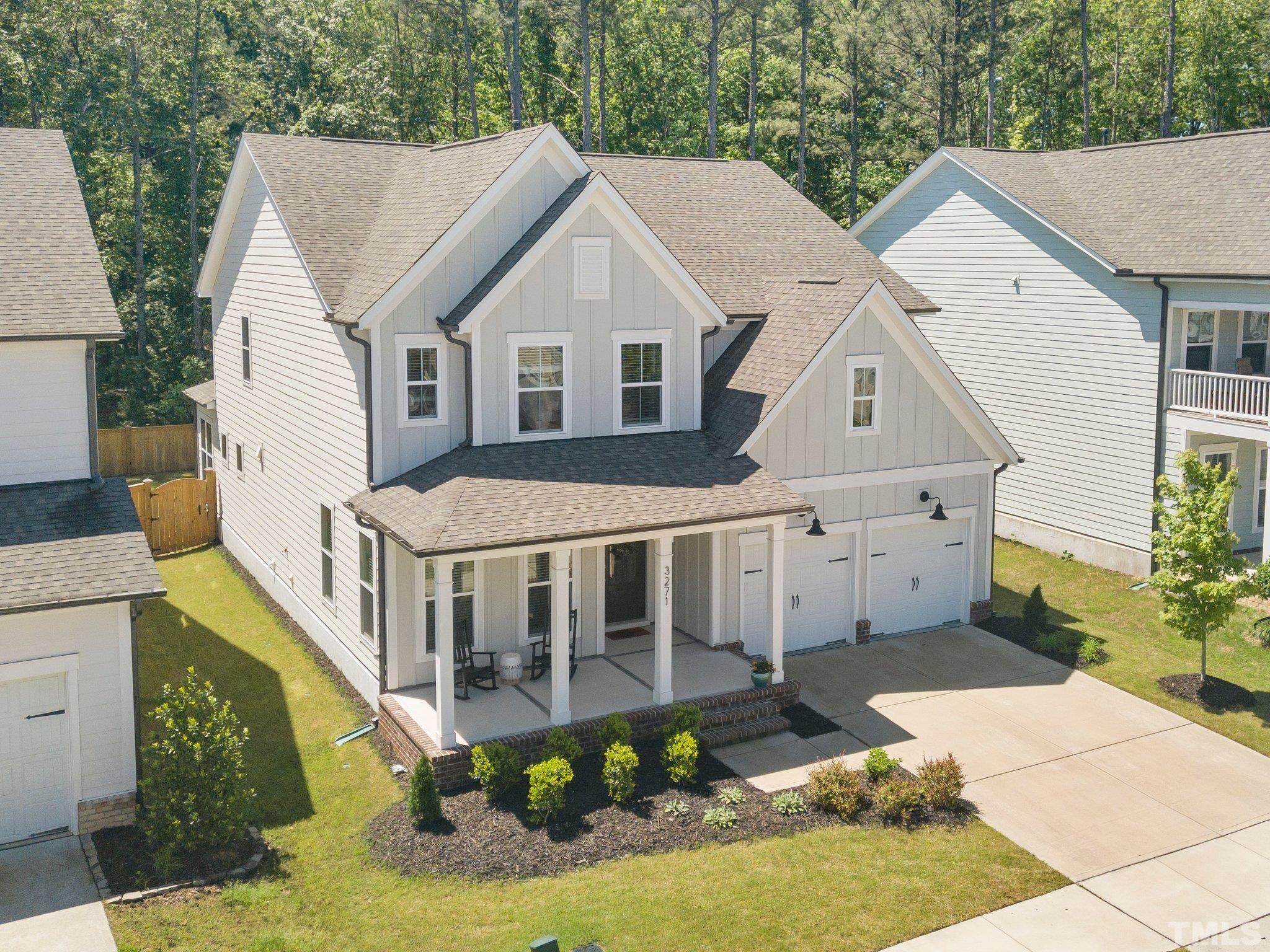 3271 Ripley River Road New Hill, NC 27562 - Photo 45 of 48 a view of a white house with a small yard plants and large tree