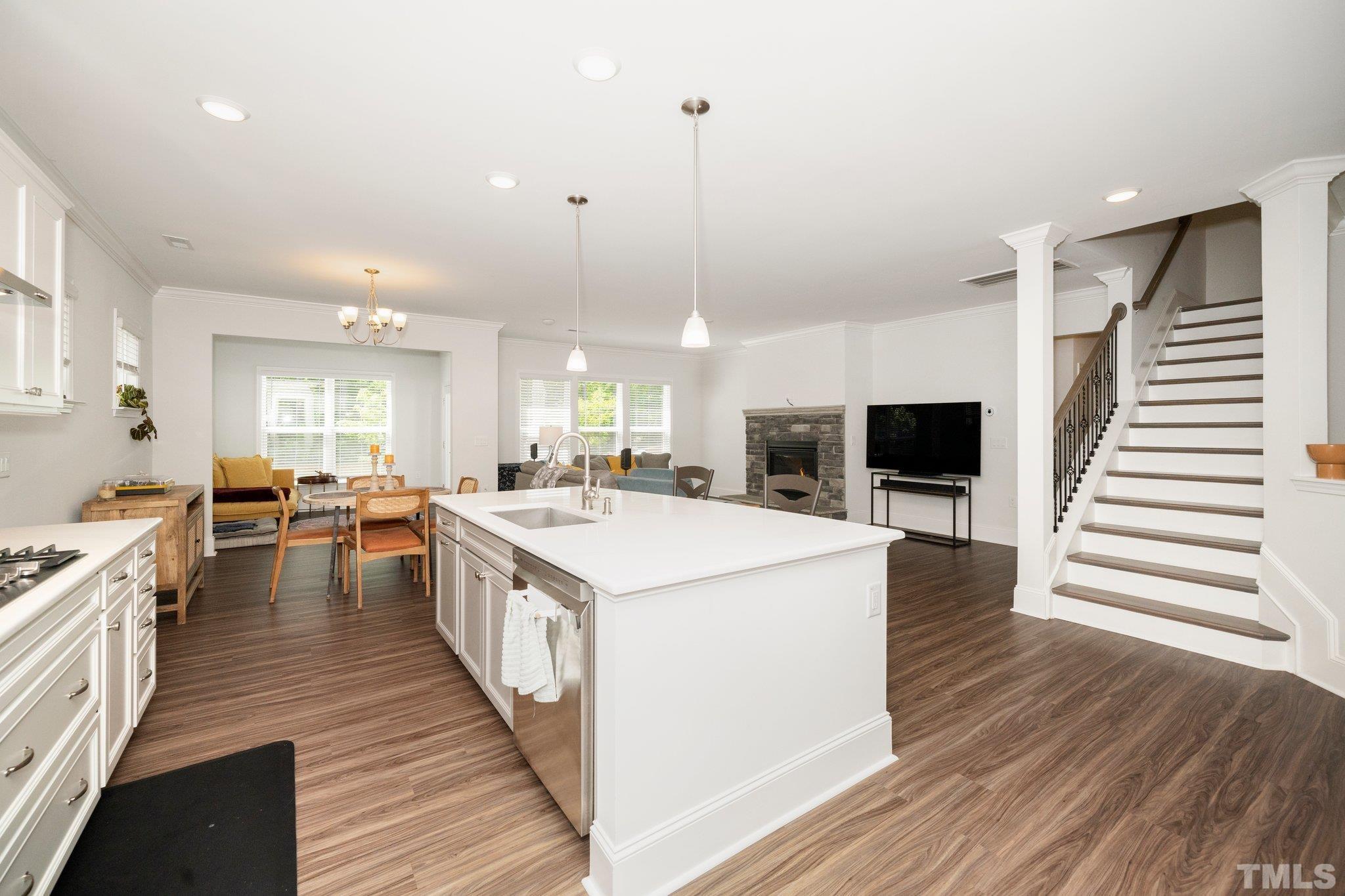 3271 Ripley River Road New Hill, NC 27562 - Photo 9 of 48 a large kitchen with stainless steel appliances kitchen island a large island in the center