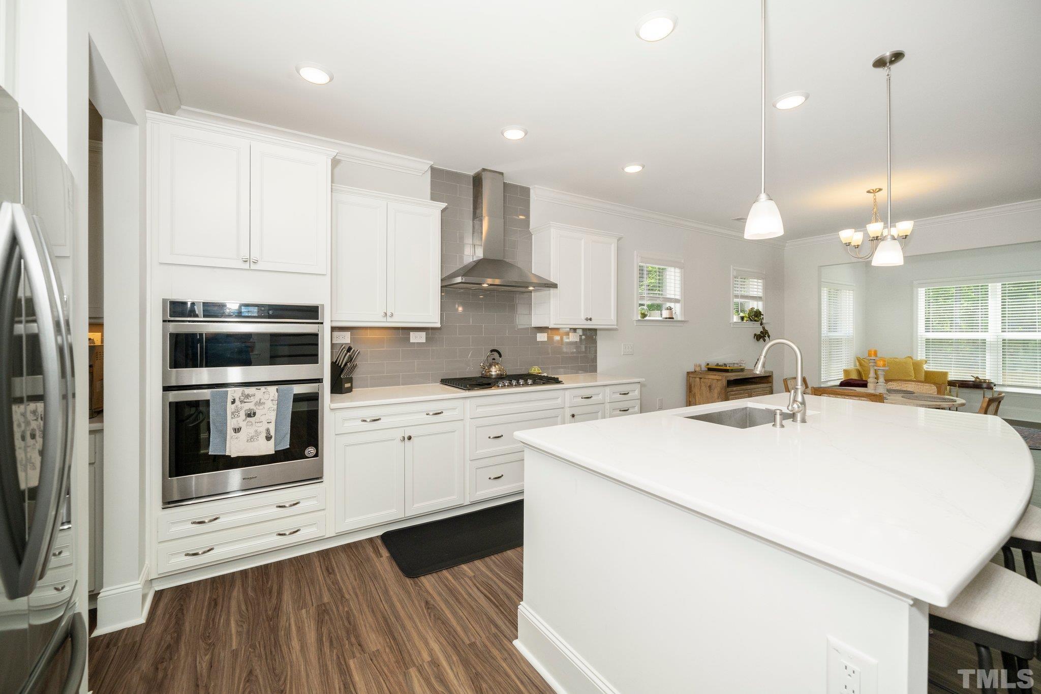 3271 Ripley River Road New Hill, NC 27562 - Photo 10 of 48 a kitchen with a stove a sink and a refrigerator