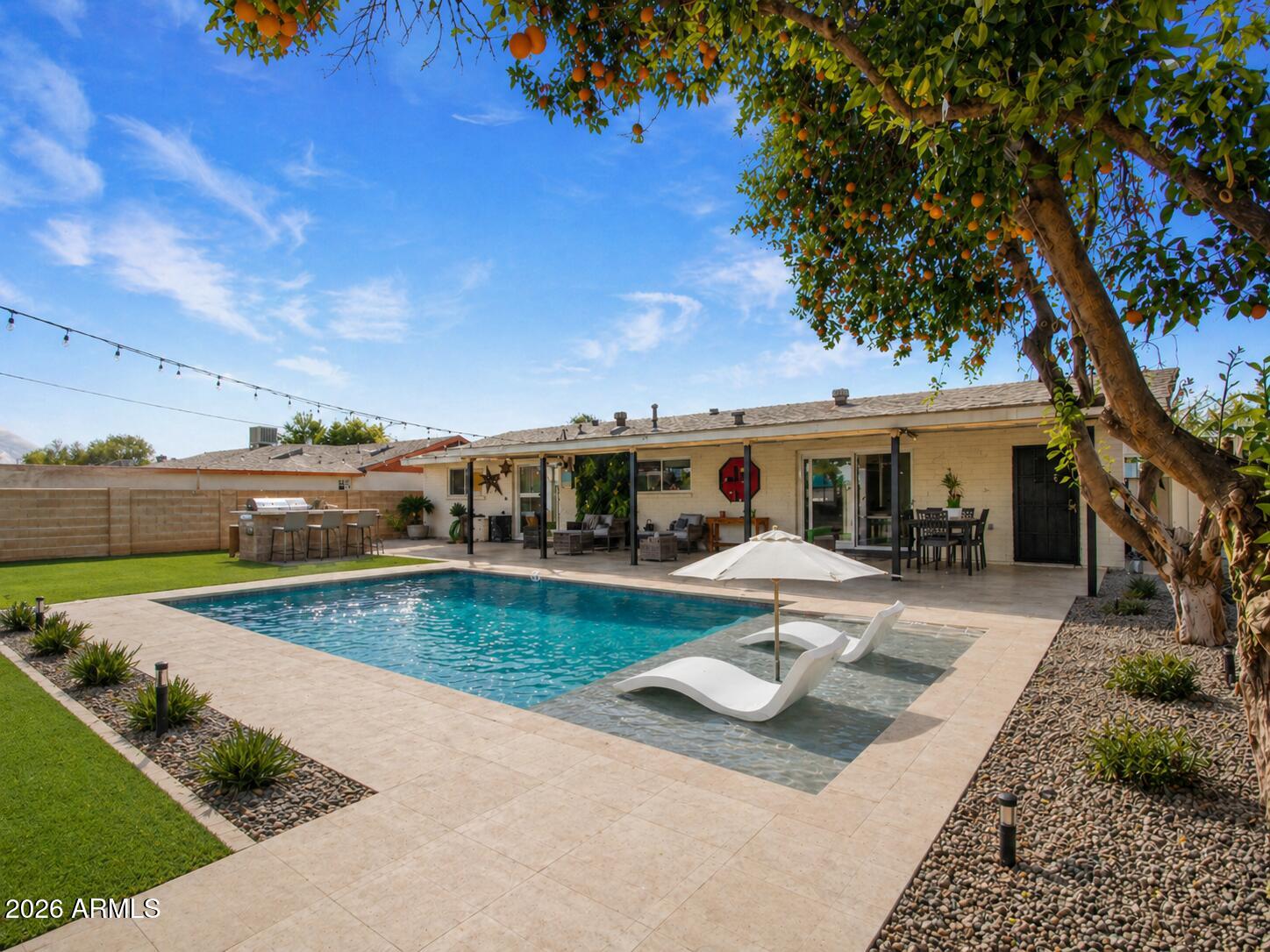 3010 East Yucca Street Phoenix, AZ 85028 - Photo 15 of 58 a view of a house with swimming pool and sitting area