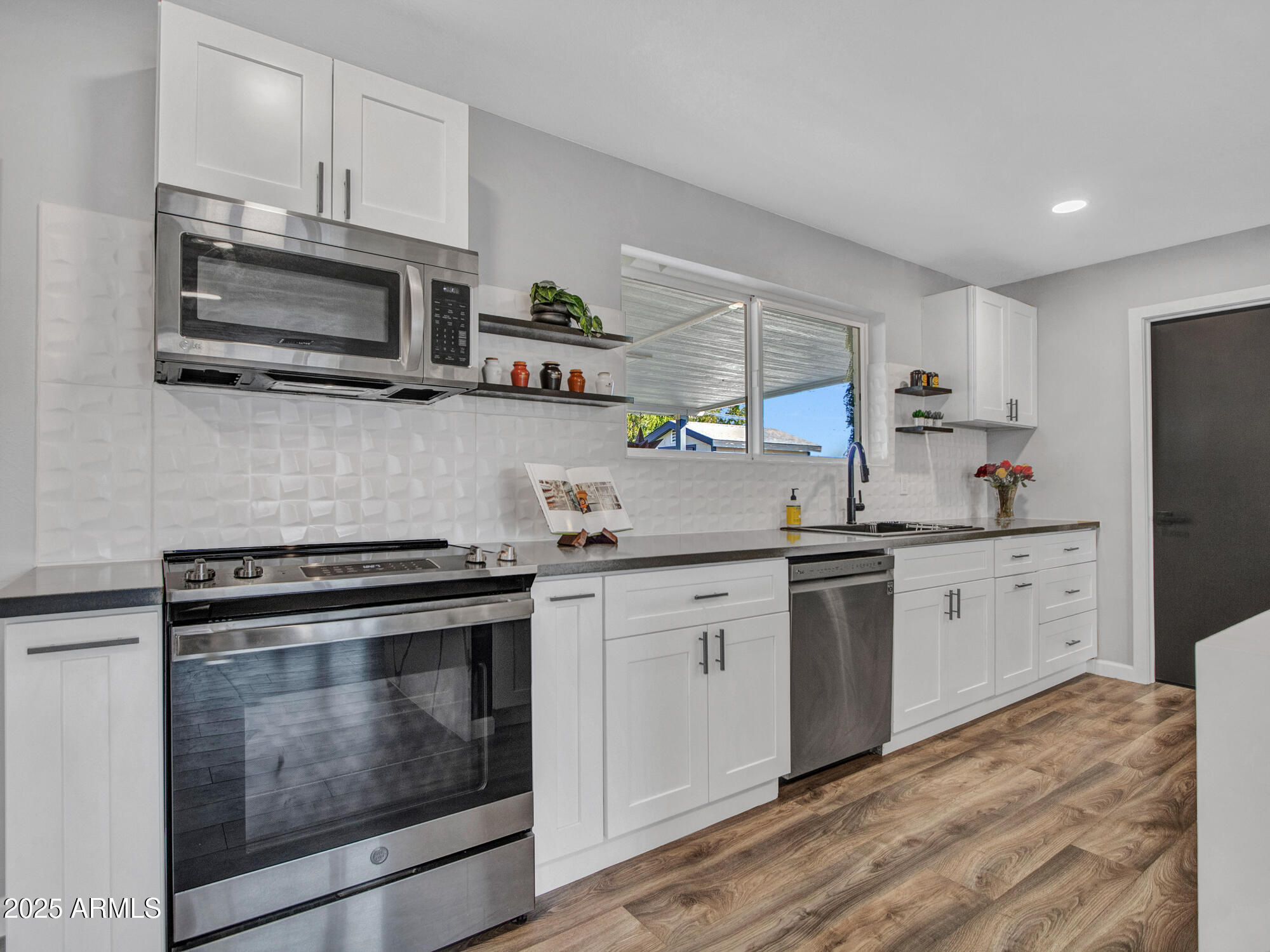 3010 East Yucca Street Phoenix, AZ 85028 - Photo 24 of 58 a kitchen with granite countertop cabinets stainless steel appliances and a window