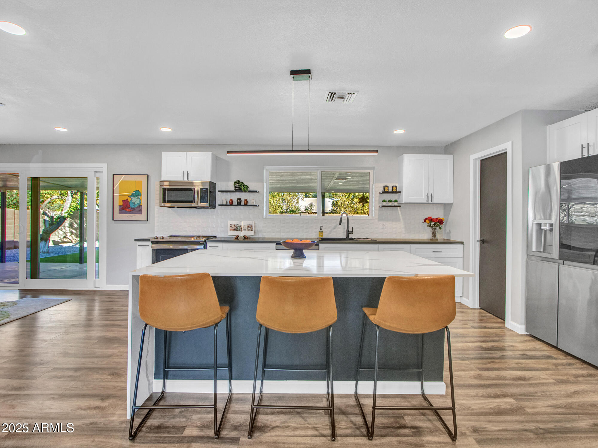 3010 East Yucca Street Phoenix, AZ 85028 - Photo 2 of 58 a kitchen with stainless steel appliances granite countertop a table and chairs in it