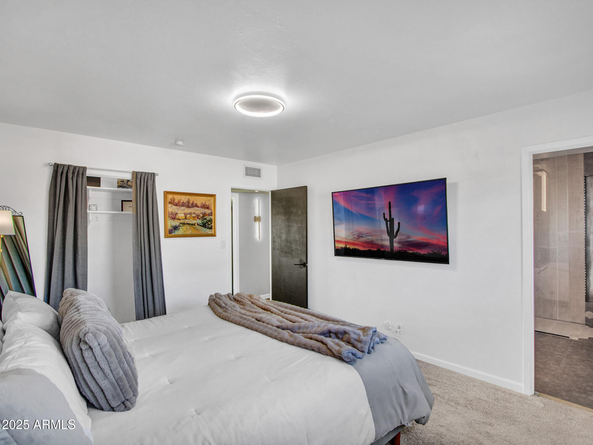 3010 East Yucca Street Phoenix, AZ 85028 - Photo 30 of 58 a bedroom with a bed and a flat screen tv