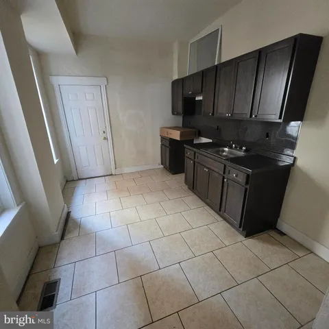 a kitchen with stainless steel appliances a sink a stove a microwave and cabinets