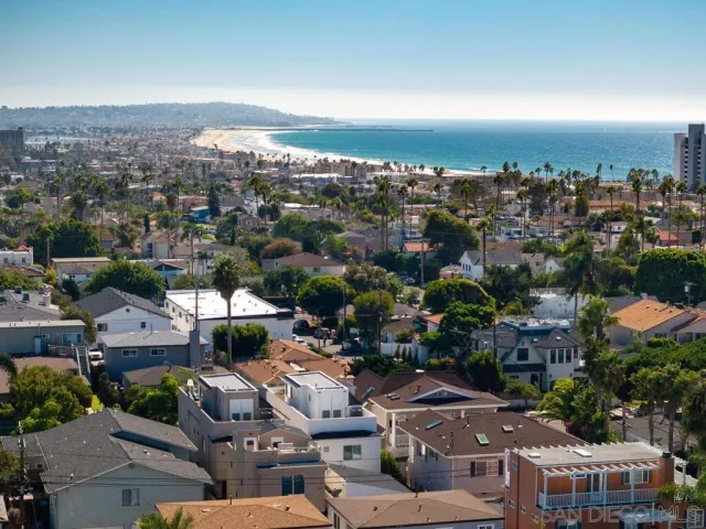 an aerial view of residential houses with city view