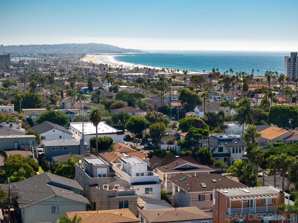 an aerial view of residential houses with city view