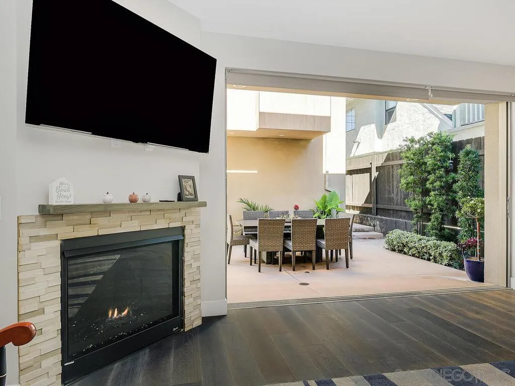 938 Opal Street San Diego, CA 92109 - Photo 18 of 70 a living room with furniture a fireplace and a flat screen tv