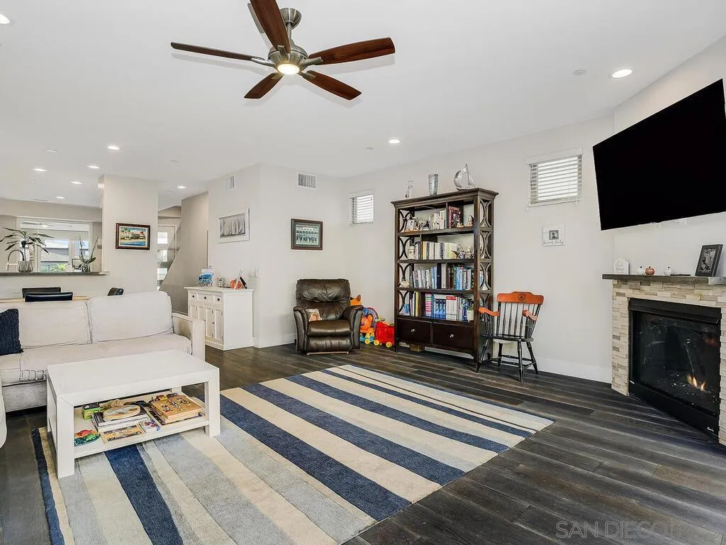 938 Opal Street San Diego, CA 92109 - Photo 19 of 70 a living room with furniture and a flat screen tv