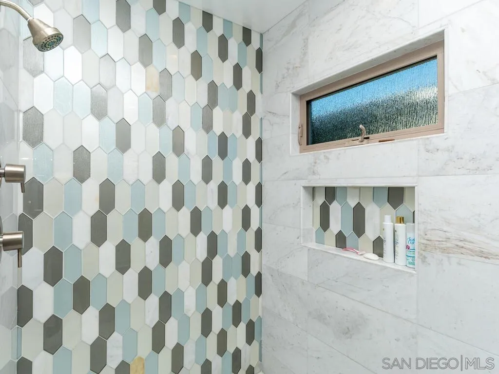 938 Opal Street San Diego, CA 92109 - Photo 29 of 70 a living room with a fireplace and flat screen tv