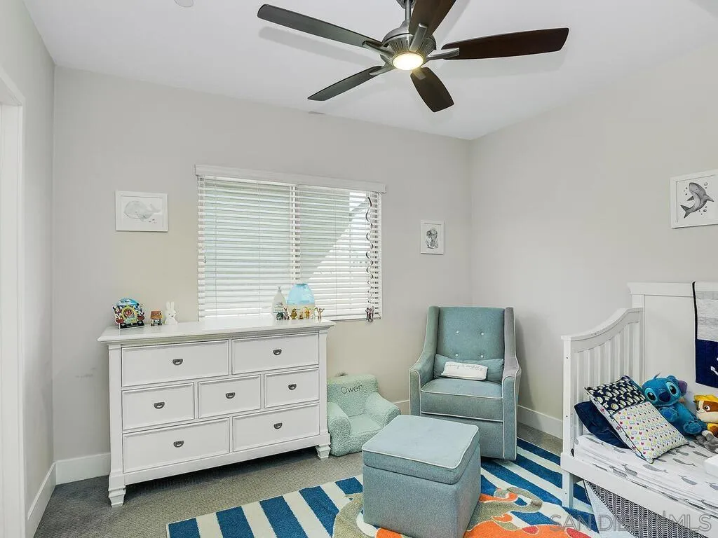 938 Opal Street San Diego, CA 92109 - Photo 31 of 70 a bedroom with a bed and a dresser in it