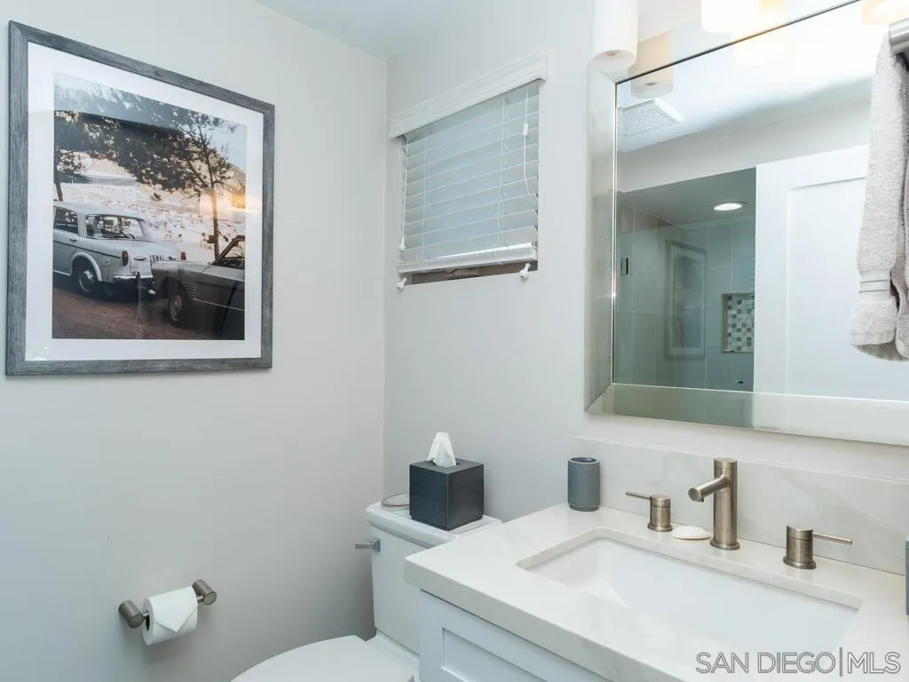 938 Opal Street San Diego, CA 92109 - Photo 38 of 70 a bathroom with a toilet sink and mirror
