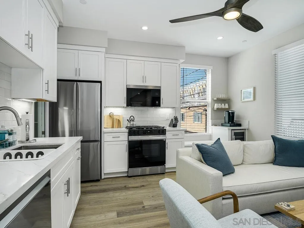 938 Opal Street San Diego, CA 92109 - Photo 49 of 70 a kitchen with stainless steel appliances granite countertop a refrigerator stove microwave and sink
