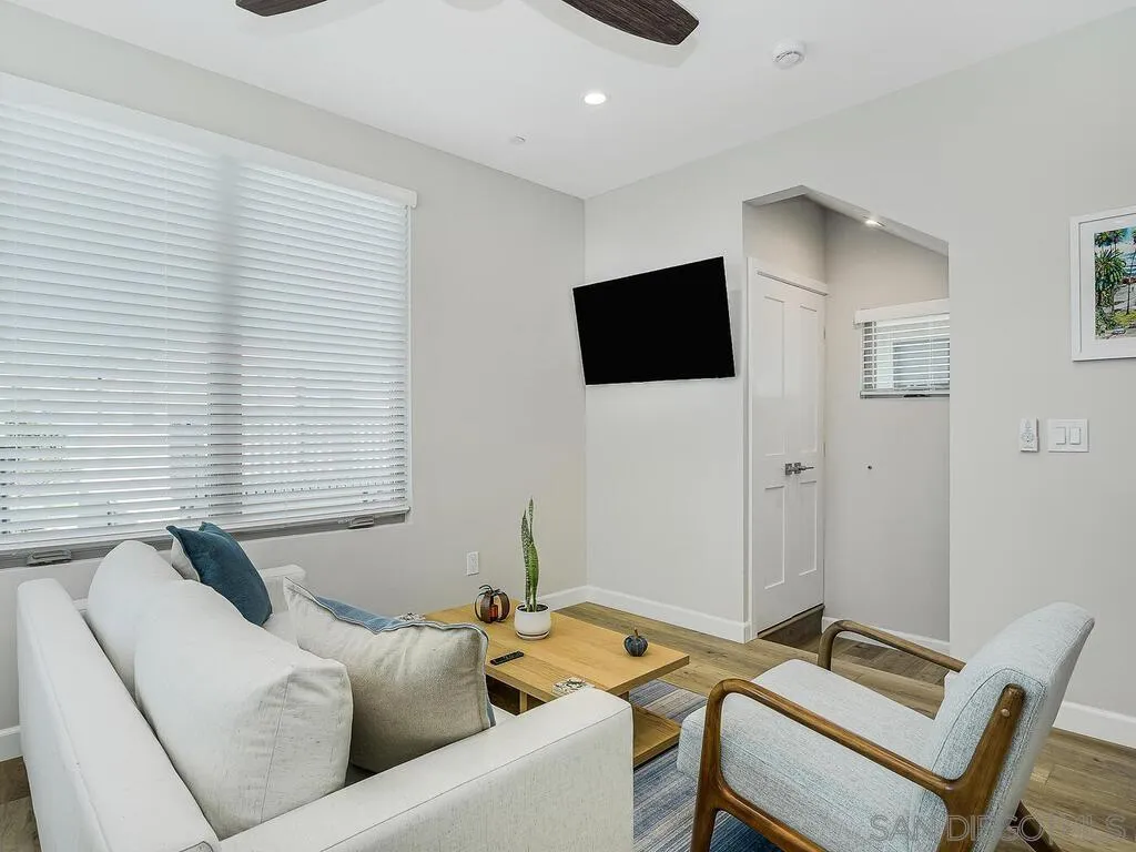 938 Opal Street San Diego, CA 92109 - Photo 50 of 70 a living room with furniture and a flat screen tv