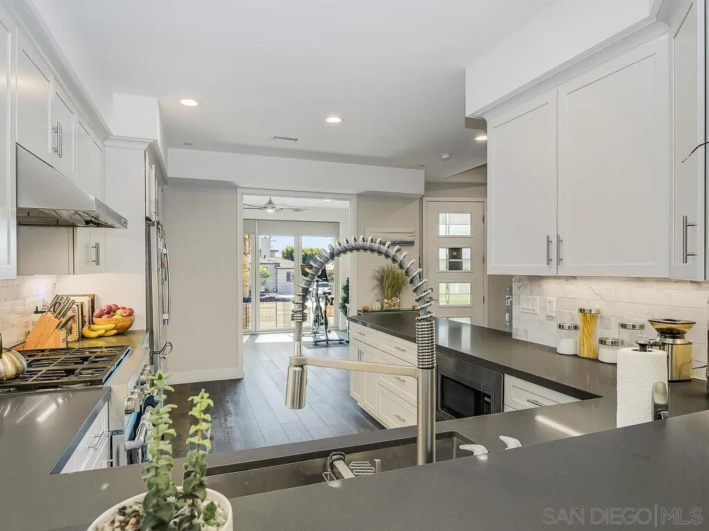 938 Opal Street San Diego, CA 92109 - Photo 9 of 70 a kitchen with stainless steel appliances granite countertop a sink and a stove