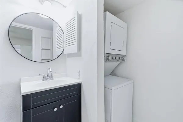 a bathroom with a toilet a sink and a mirror