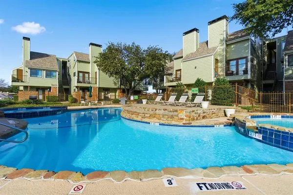 a swimming pool view with a outdoor seating