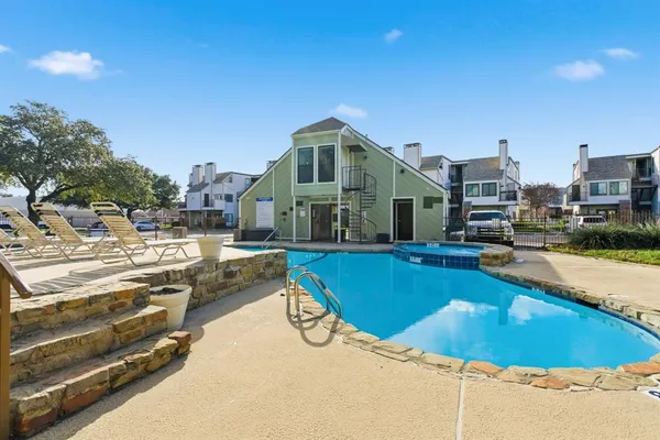 a view of a swimming pool with a lounge chairs