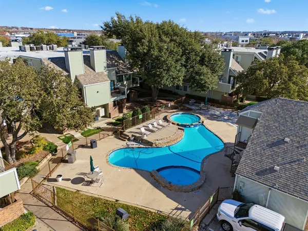 an aerial view of a house with yard swimming pool and lake view