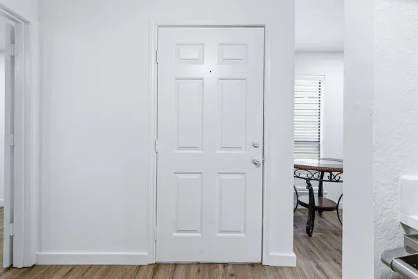 an entryway with wooden floor